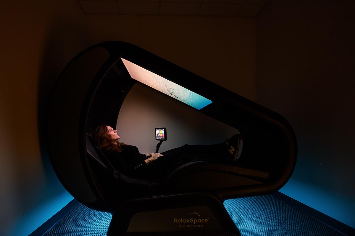 Woman relaxing in Wellness POD and Oxygen Bar in Bartlett, IL